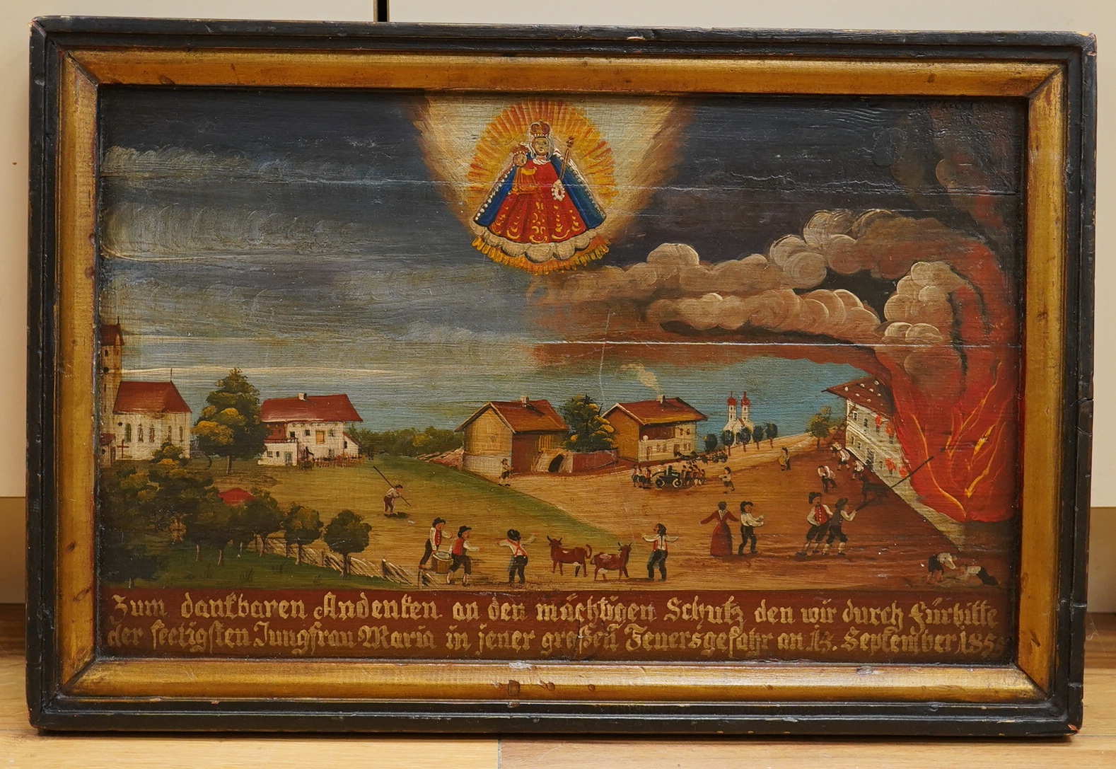 19th century naive German folklore oil on panel, Coastal village under siege, with German inscription and dated 1st September 1855, 30 x 47cm, housed in an ebonised frame. Condition - fair